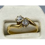An 18ct yellow gold diamond cross over ring 40 points approx., 2.5g size K