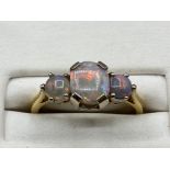 A 18ct gold 3 stone opal ring, 3.2g size L