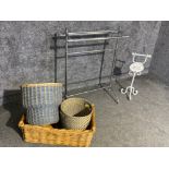 A modern towel rail with free standing toilet roll holder with 3 various baskets