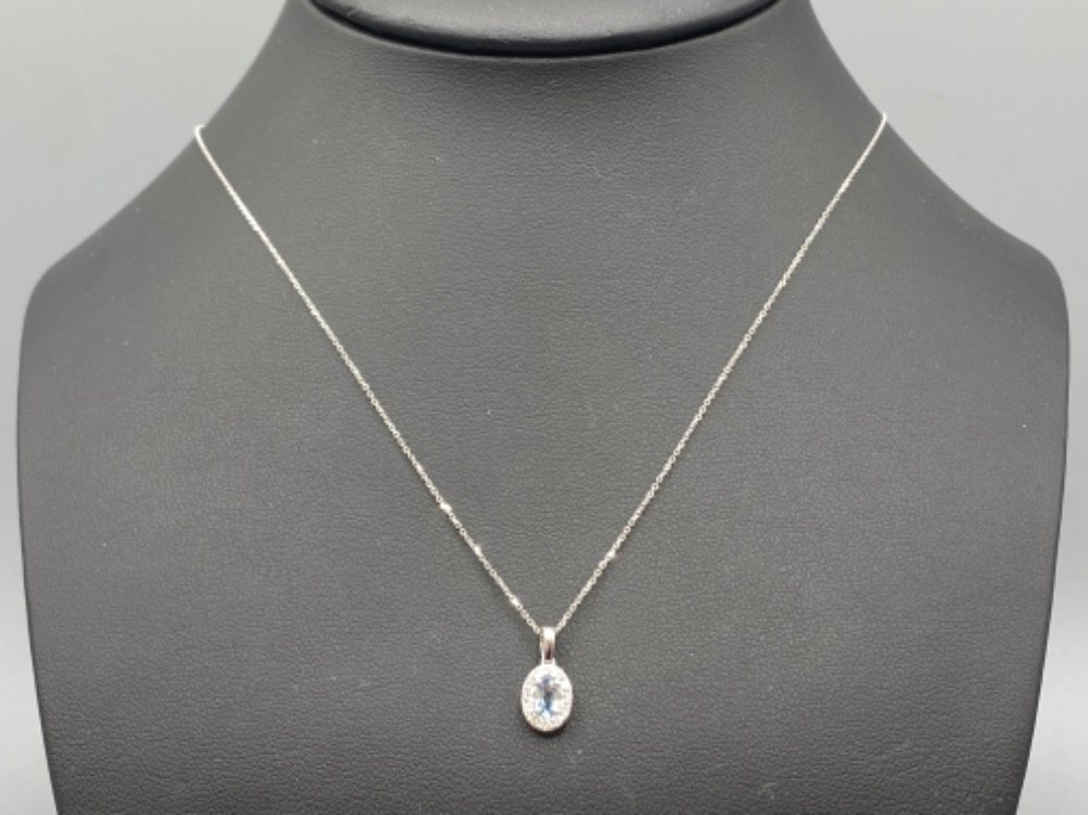 A 9ct white gold aquamarine and diamond pendant necklace, 1.4g 46cm length