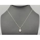 A 9ct white gold aquamarine and diamond pendant necklace, 1.4g 46cm length