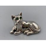 A silver figure of a cat with emerald eyes, 10.8g
