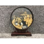 Oriental hand carved cork sculpture in a round glass free standing frame