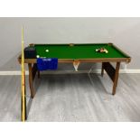 A Ambassador 6ft by 3 ft pool table includes balls and cues