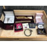 Wooden counter top display case containing costume jewellery including bangles watches earrings etc