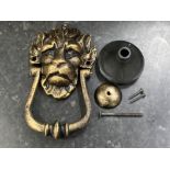 A reproduction cast metal 10 Downing Street knocker in the form of a lion, with fittings