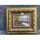 An oil painting of a woodland scene indistinctly signed 15 x 21cm in ornate frame