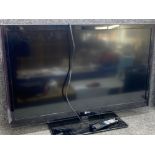 LG 42” flat screen TV on stand with remote