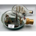 2 signed dimple bottles with ship and church in them dated 1941 & 1976