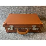 Small brown suitcase with interesting rustic contents including horn carving set