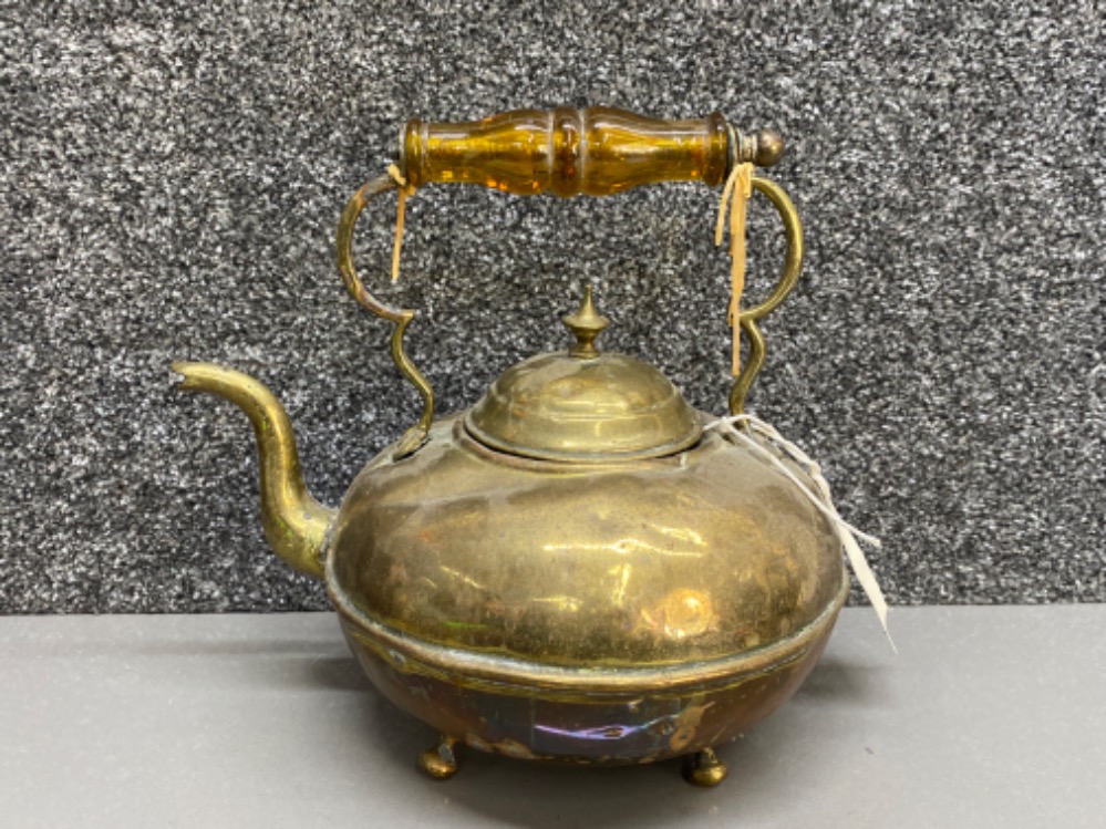 Antique brass kettle with amber glass handle