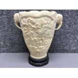 Vintage faux ivory (resin) vase with 3D relief carvings & twin elephant head handles, on wooden