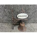 A outdoor wall hanging door bell which says Welcome