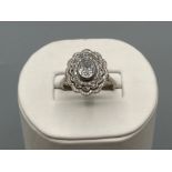 Beautiful ladies 18ct white gold diamond cluster ring, featuring oval shaped diamond centre stone