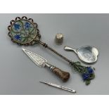 Three silver items to include a thimble, propelling pencil and a small mirror together with a