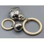 Two silver baby rattles to include a spherical shaped one by Crisford & sons Ltd with Birmingham