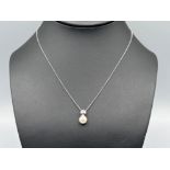 Ladies 18ct white gold Pearl and diamond pendant with 18ct white gold chain. (3.38g)