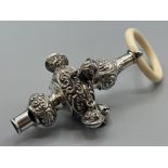 An Edwardian silver baby’s rattle/whistle by E.J.Trevitt & sons, Chester 1905, with bone handle,