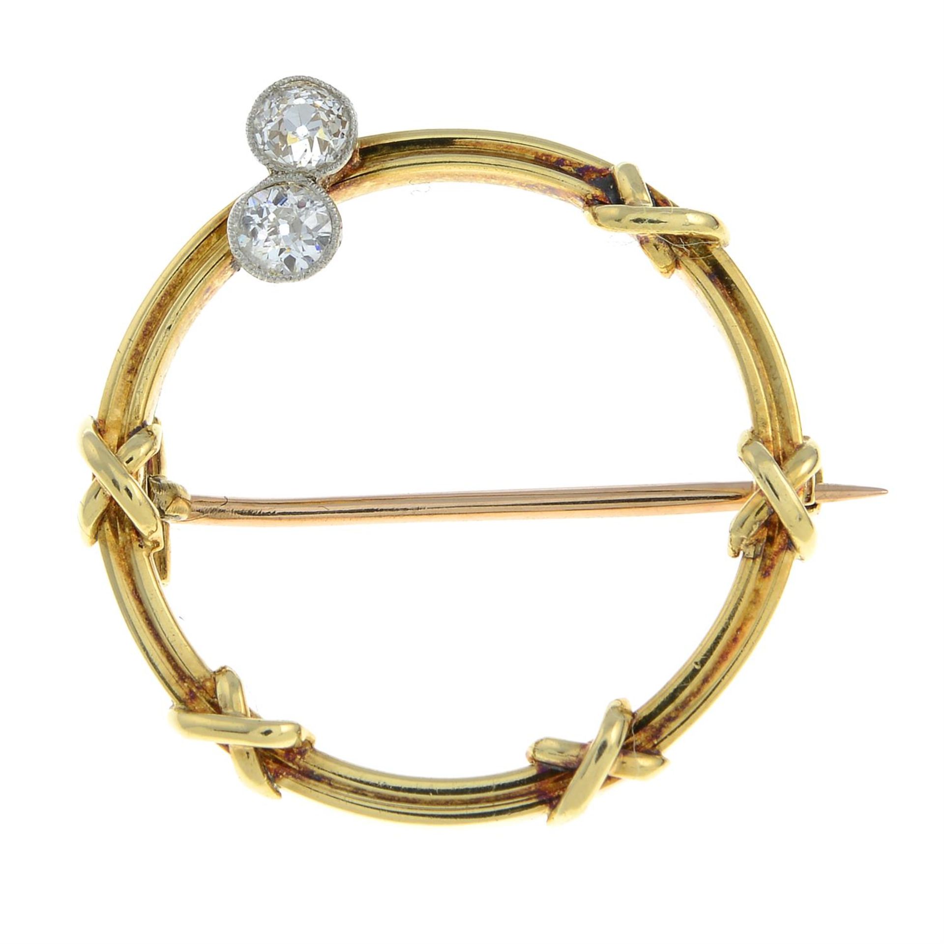 An early 20th century 15ct gold circular brooch, with cross motif and old-cut diamond two-stone