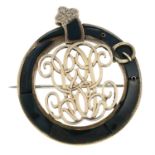 A bloodstone buckle motif monogram brooch.