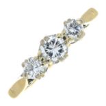 A mid 20th century gold brilliant-cut diamond three-stone ring.