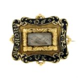 An early Victorian gold black enamel memorial brooch.