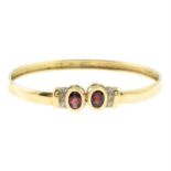 A garnet and diamond bangle.