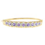 A 9ct gold amethyst bangle, with diamond spacers.