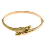 A late Victorian 9ct gold crossover bangle, depicting snake motif.