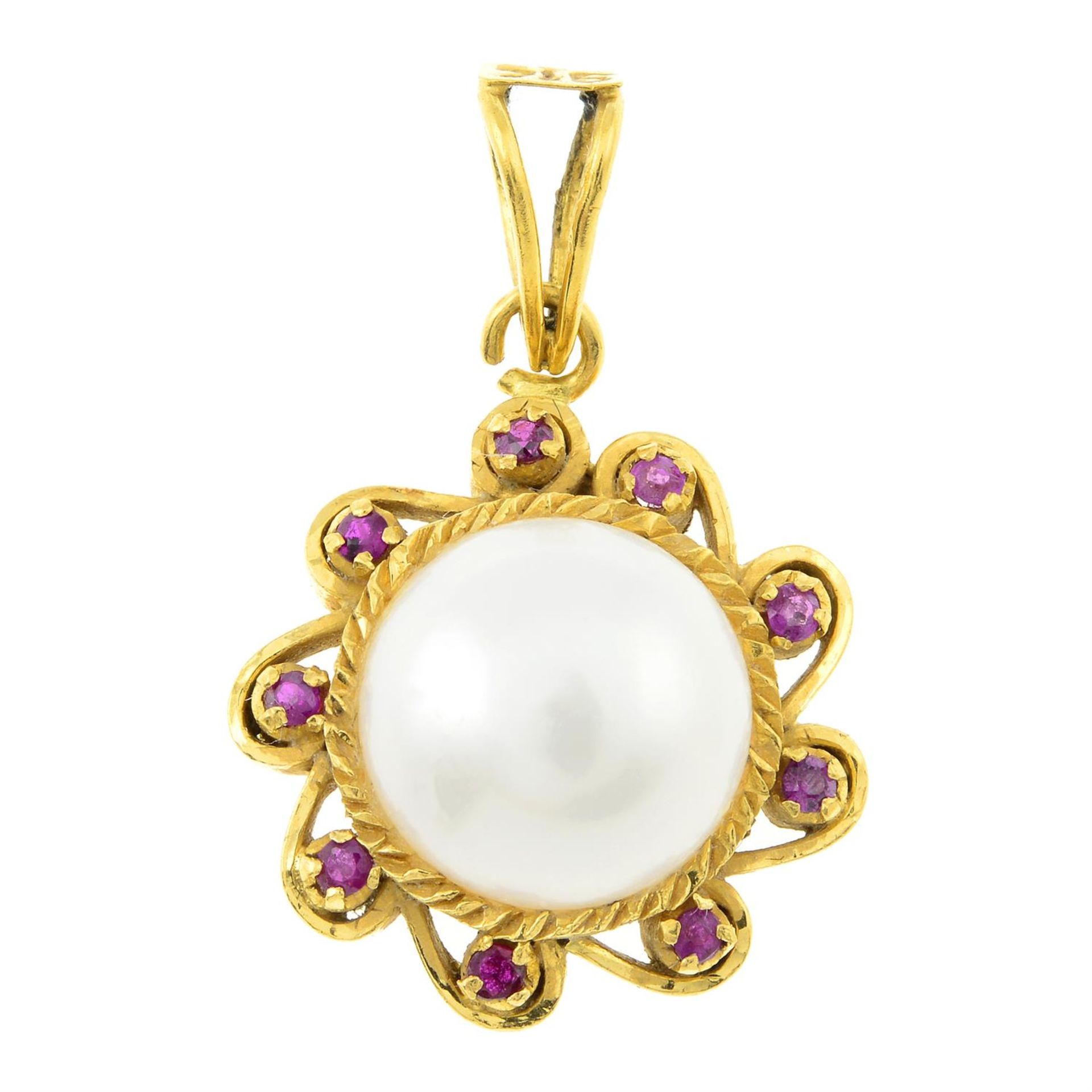 A mabe pearl and synthetic ruby cluster pendant.