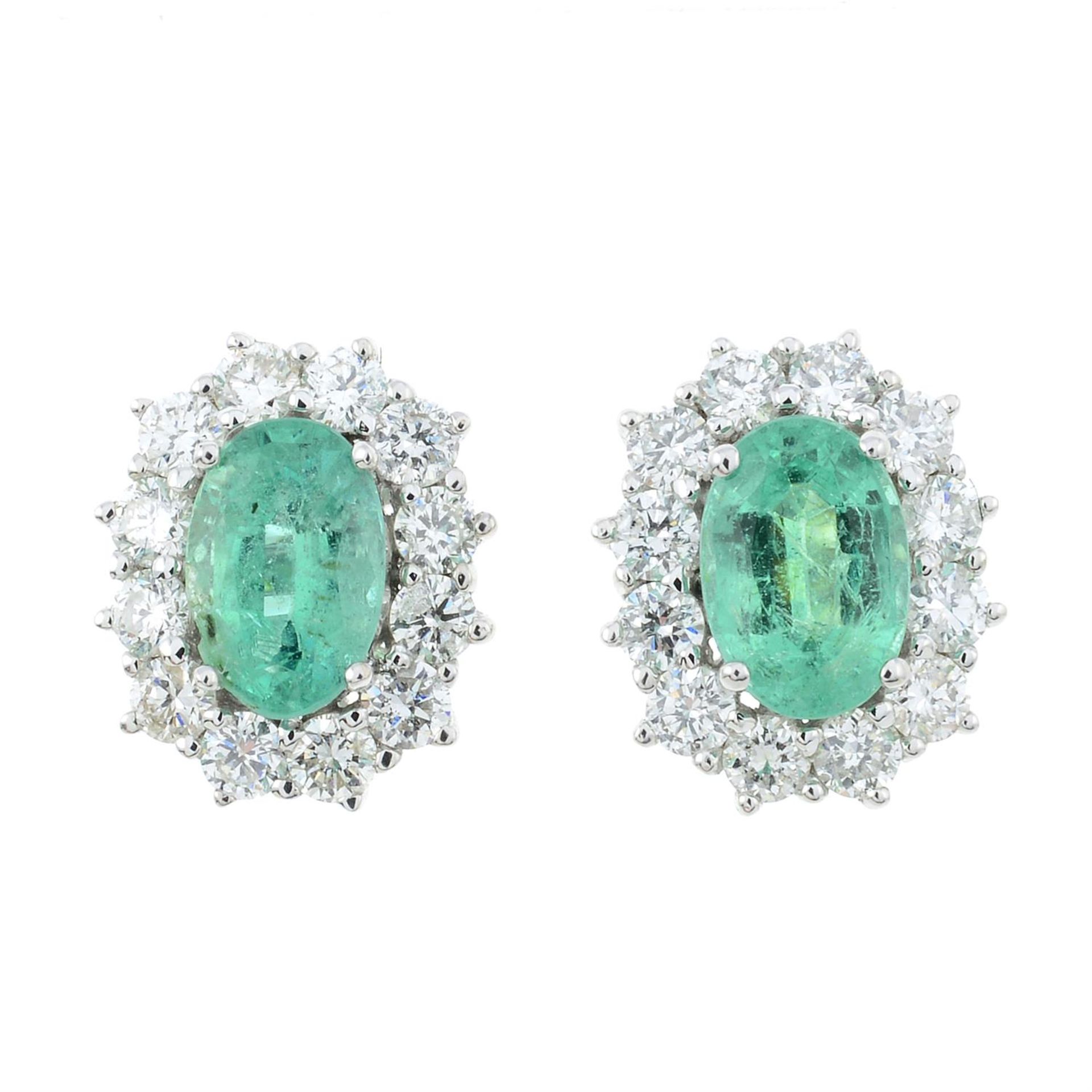 A pair of 18ct gold emerald and diamond cluster earrings.