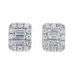 A pair of vari-cut diamond stud earrings.