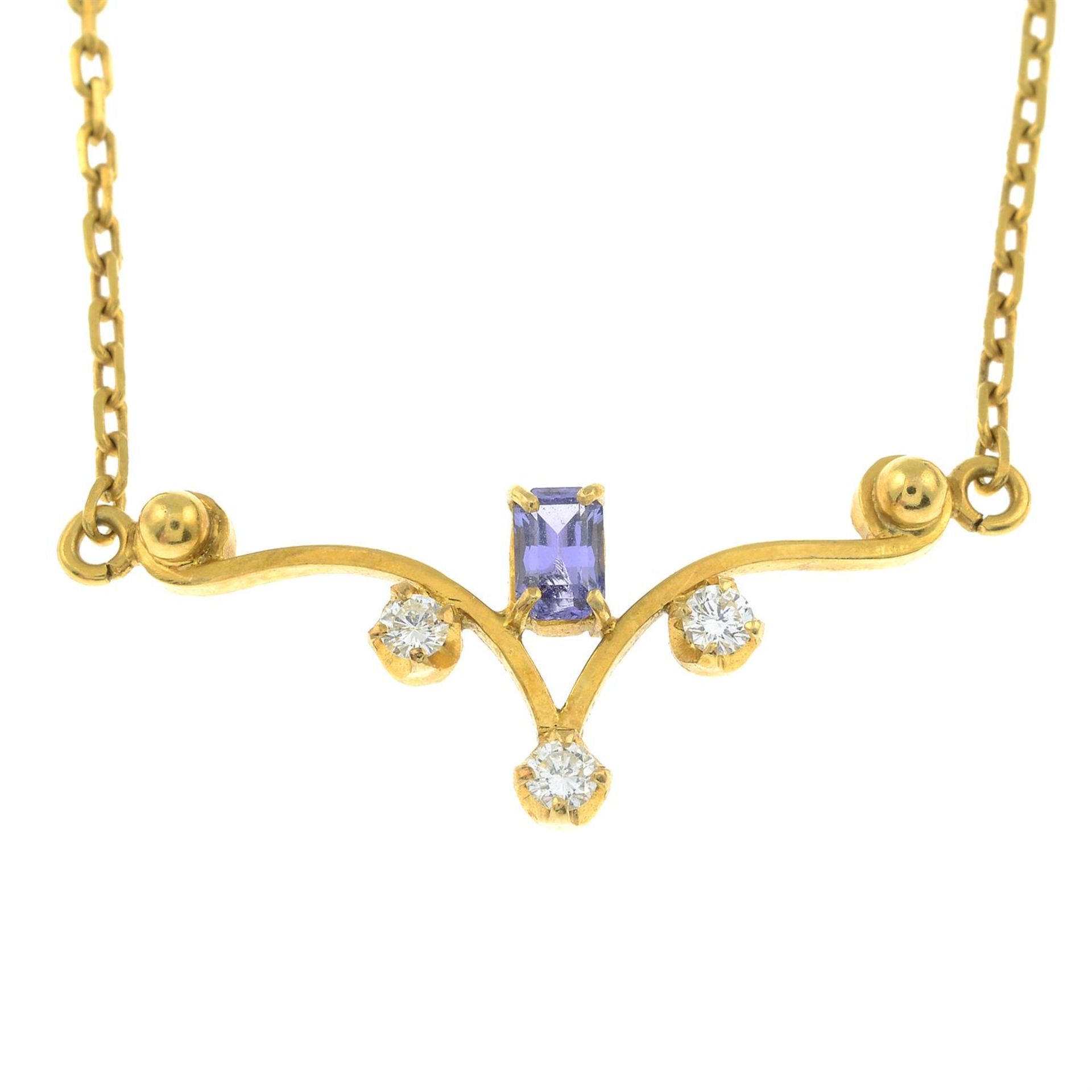 A tanzanite and brilliant-cut diamond scrolling pendant, on an integral chain.