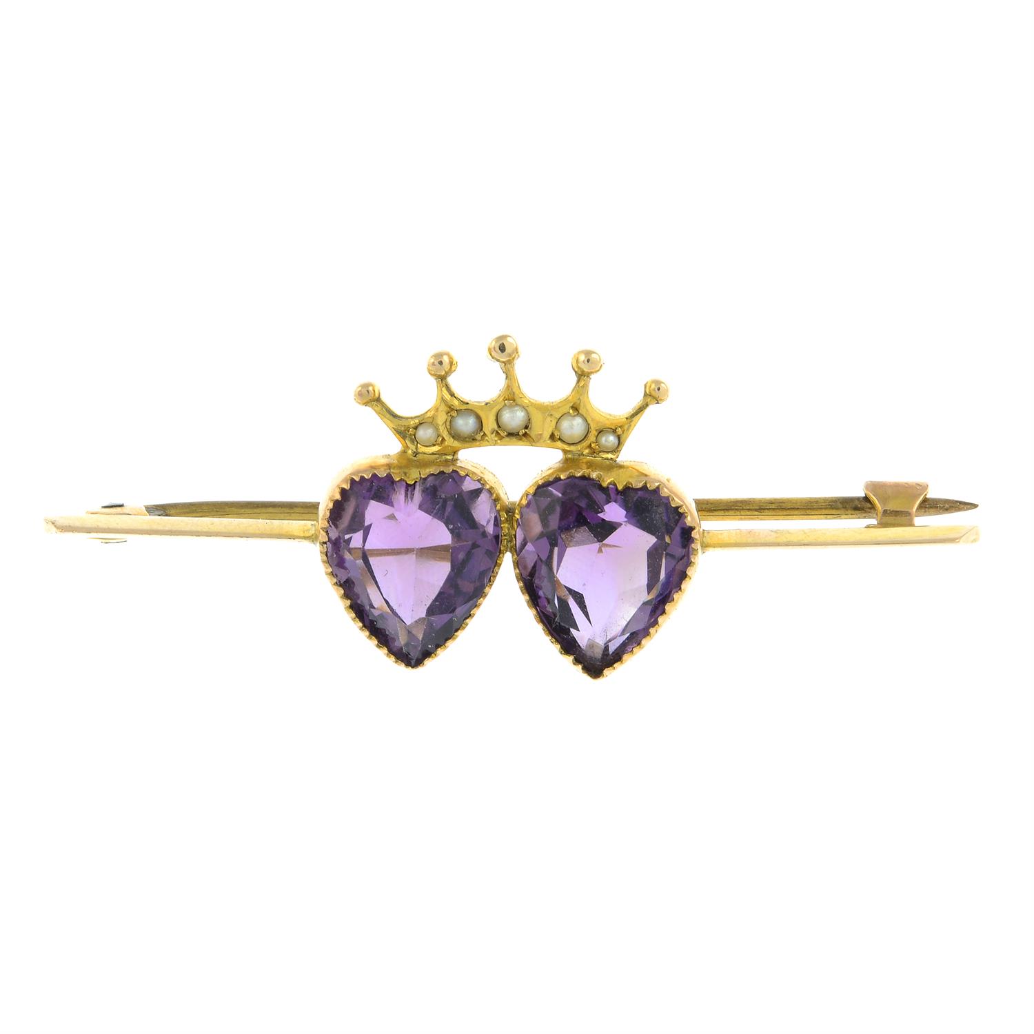 An early 20th century amethyst and seed pearl double heart and crown brooch.
