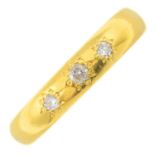 An Edwardian 22ct gold band ring, with later diamond addition.