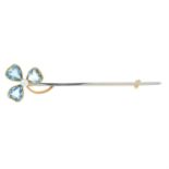 An early 20th century gold and platinum aquamarine and seed pearl shamrock bar brooch.