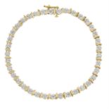 A 9ct gold illusion-set diamond line bracelet.