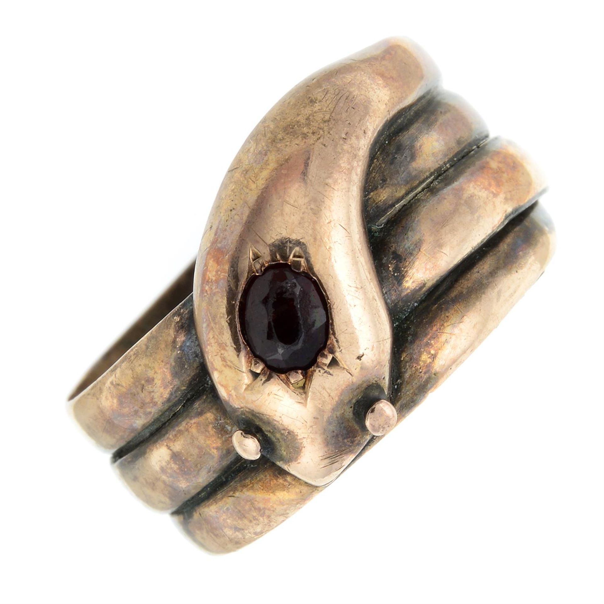 An early 20th century 9ct gold snake ring, with garnet crest.