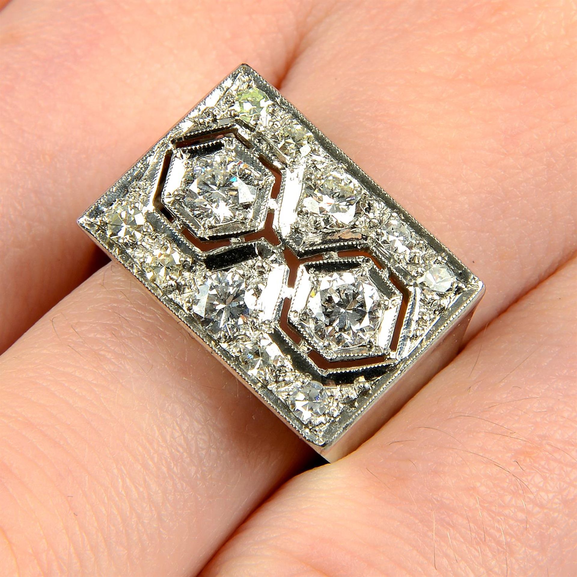 A brilliant and single-cut diamond pierced dress ring.