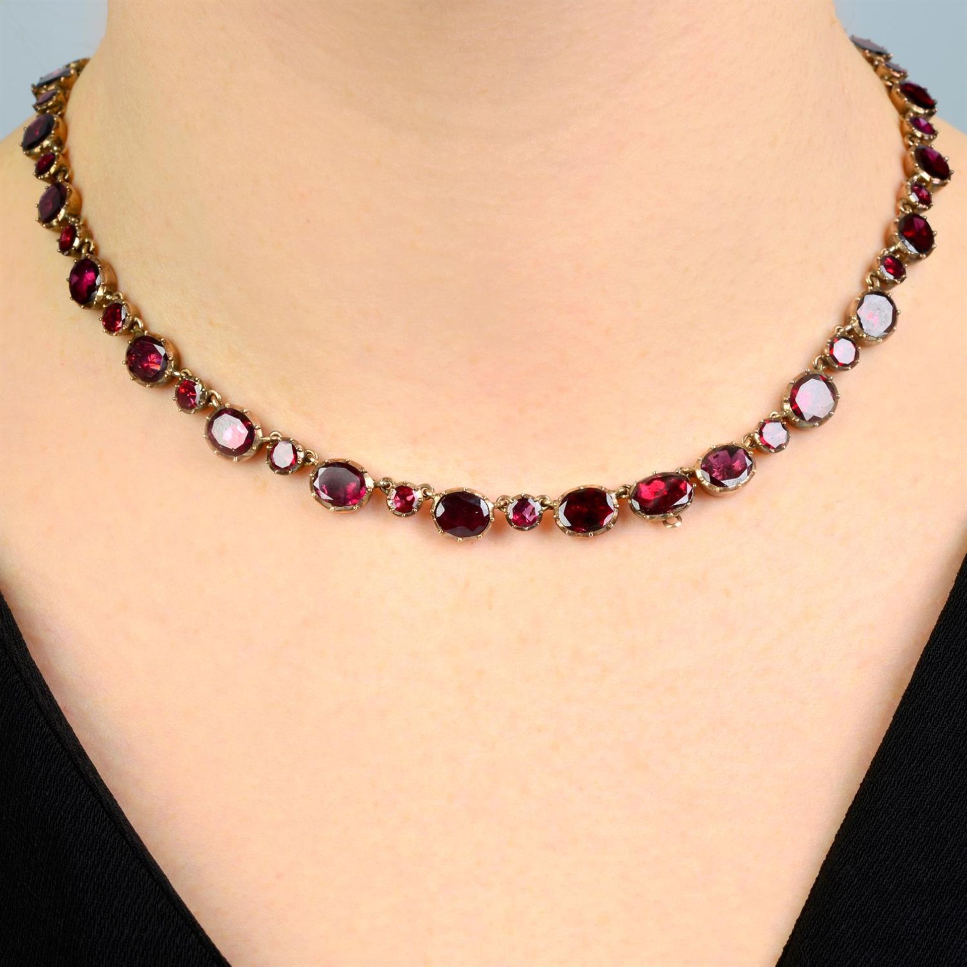 A late Georgian gold foil back garnet rivière necklace.