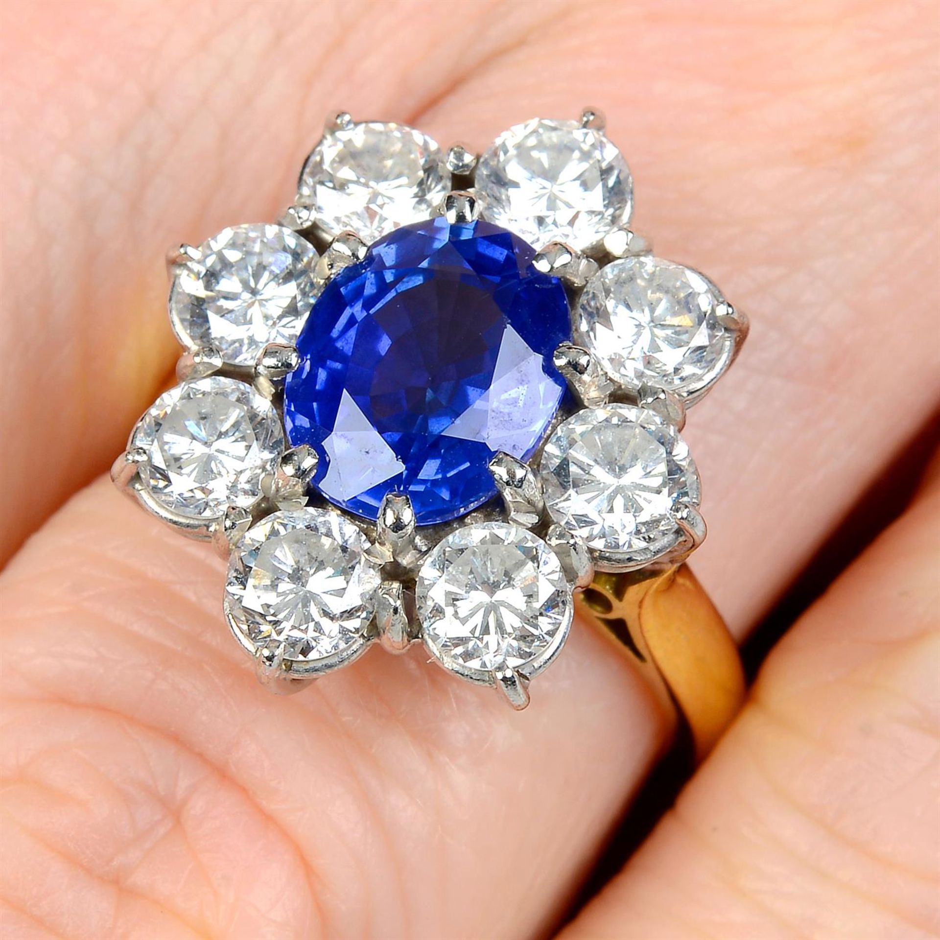 A sapphire and brilliant-cut diamond cluster ring.