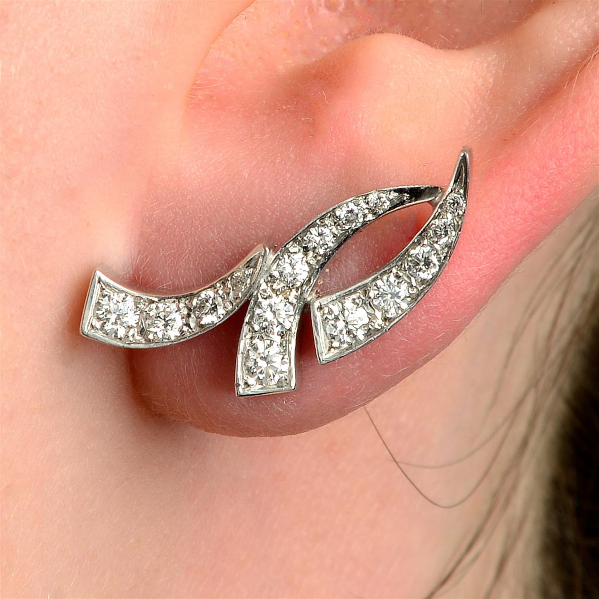 A pair of 18ct gold brilliant-cut diamond scrolling line earrings.