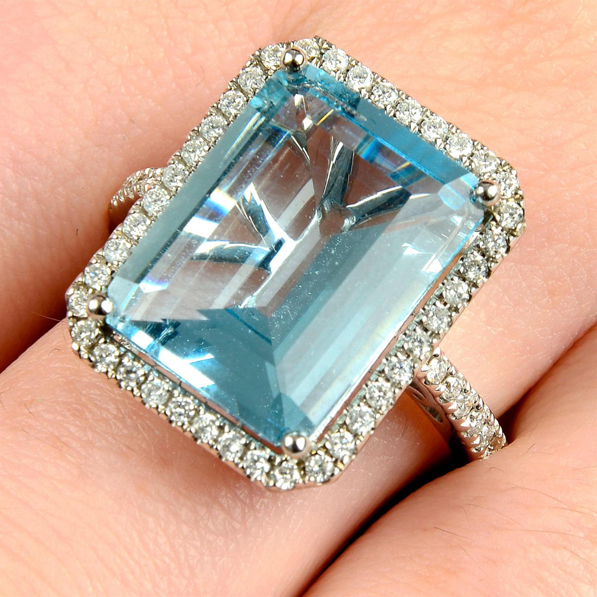 An 18ct gold aquamarine and diamond cluster ring.