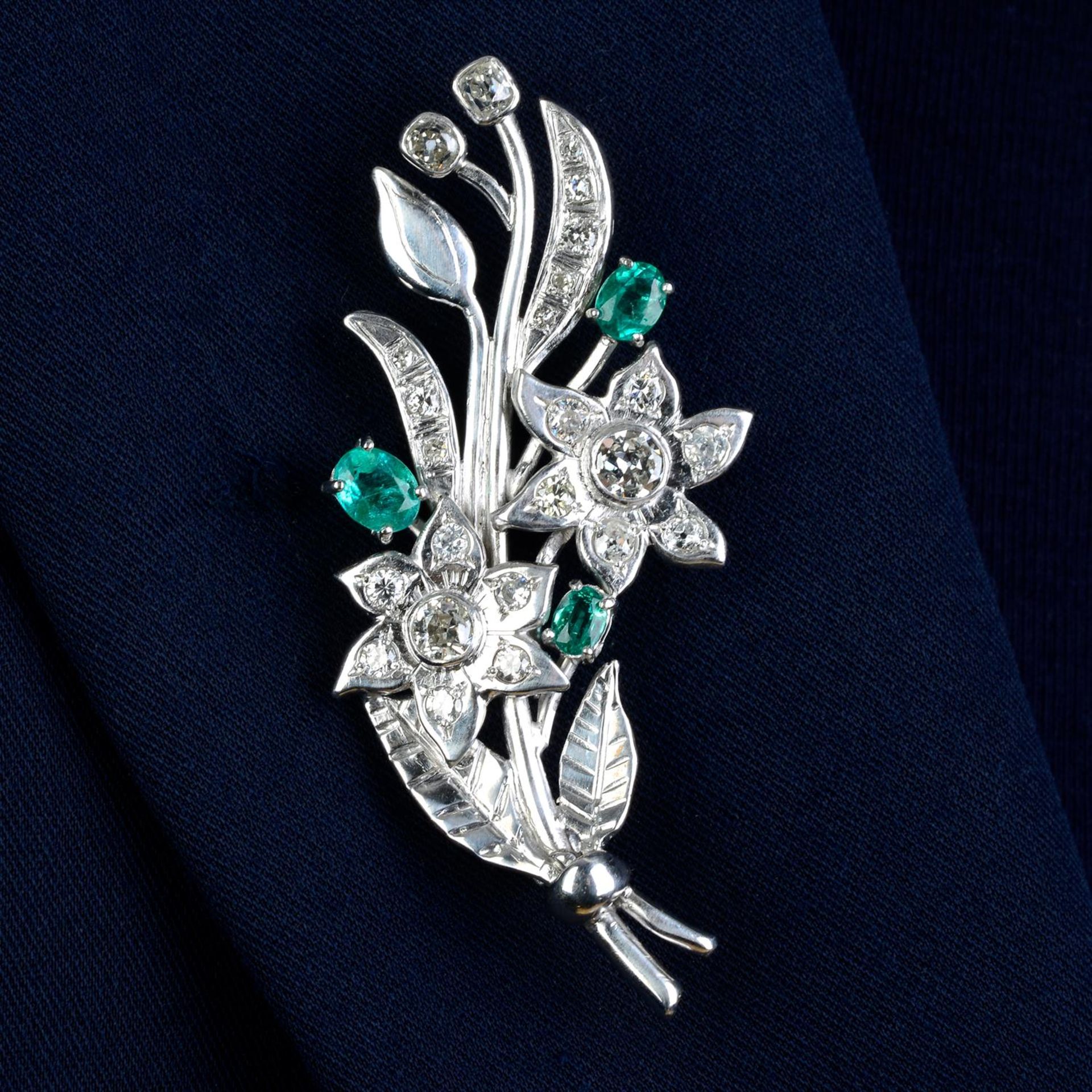 An 18ct gold diamond and emerald floral brooch.