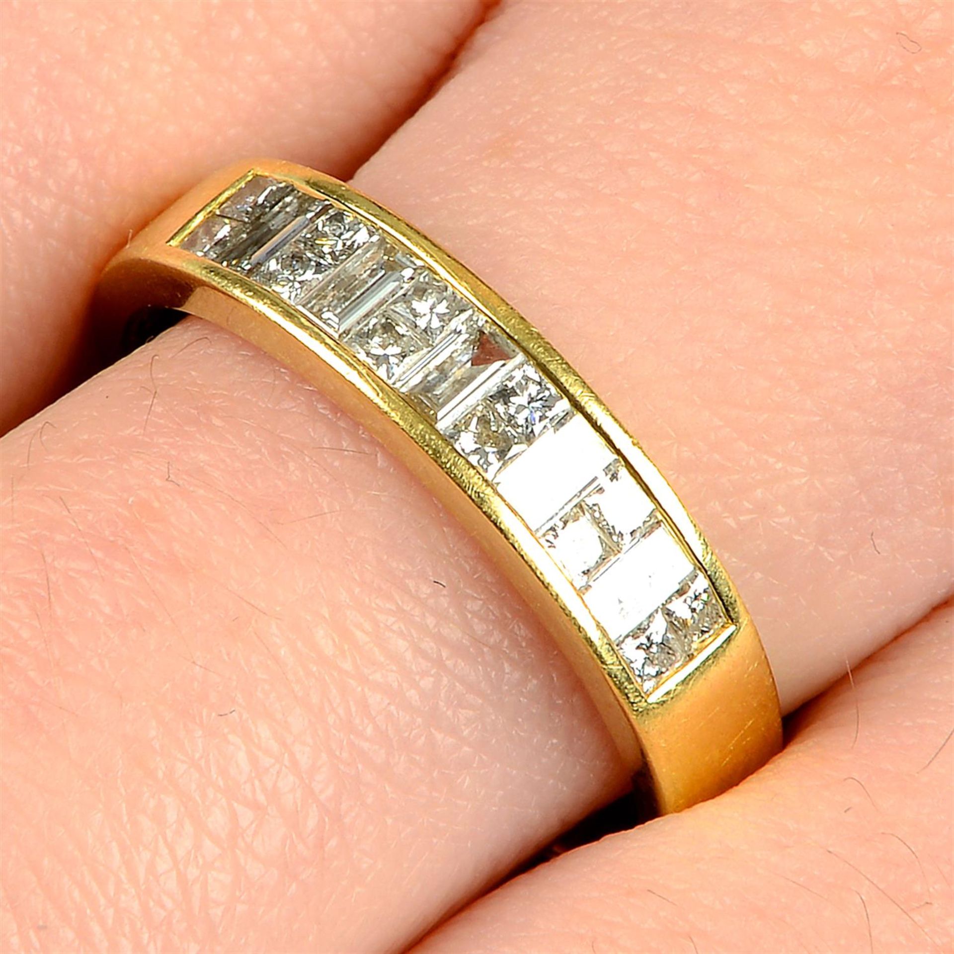 An 18ct gold baguette-cut and square-shape diamond half-eternity ring.
