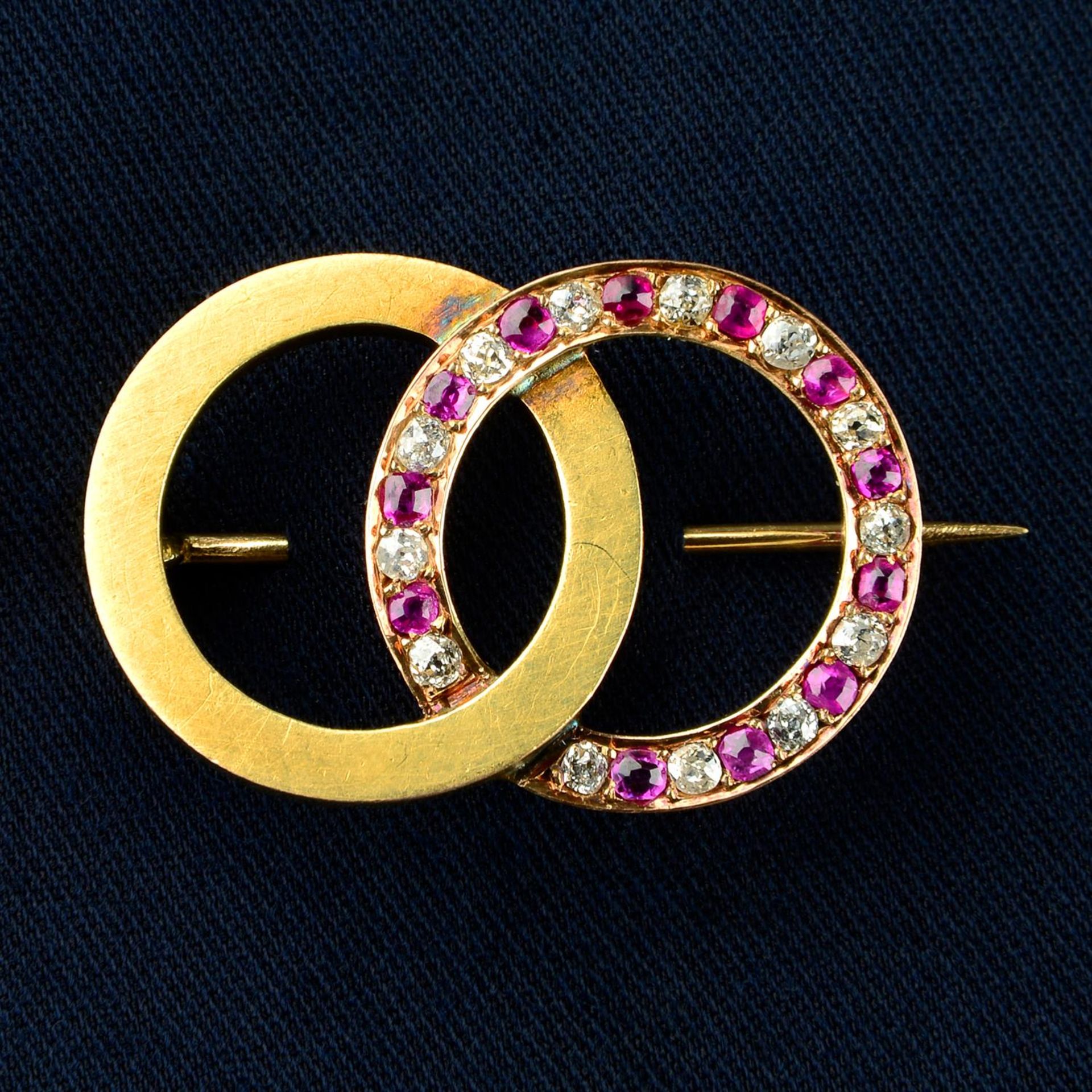 An early 20th century 18ct gold brooch, comprising alternating old-cut diamond, pink sapphire and