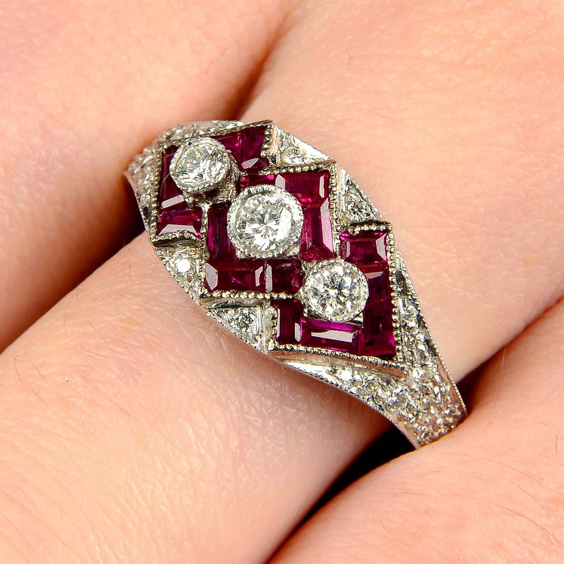 A brilliant-cut diamond and ruby dress ring.
