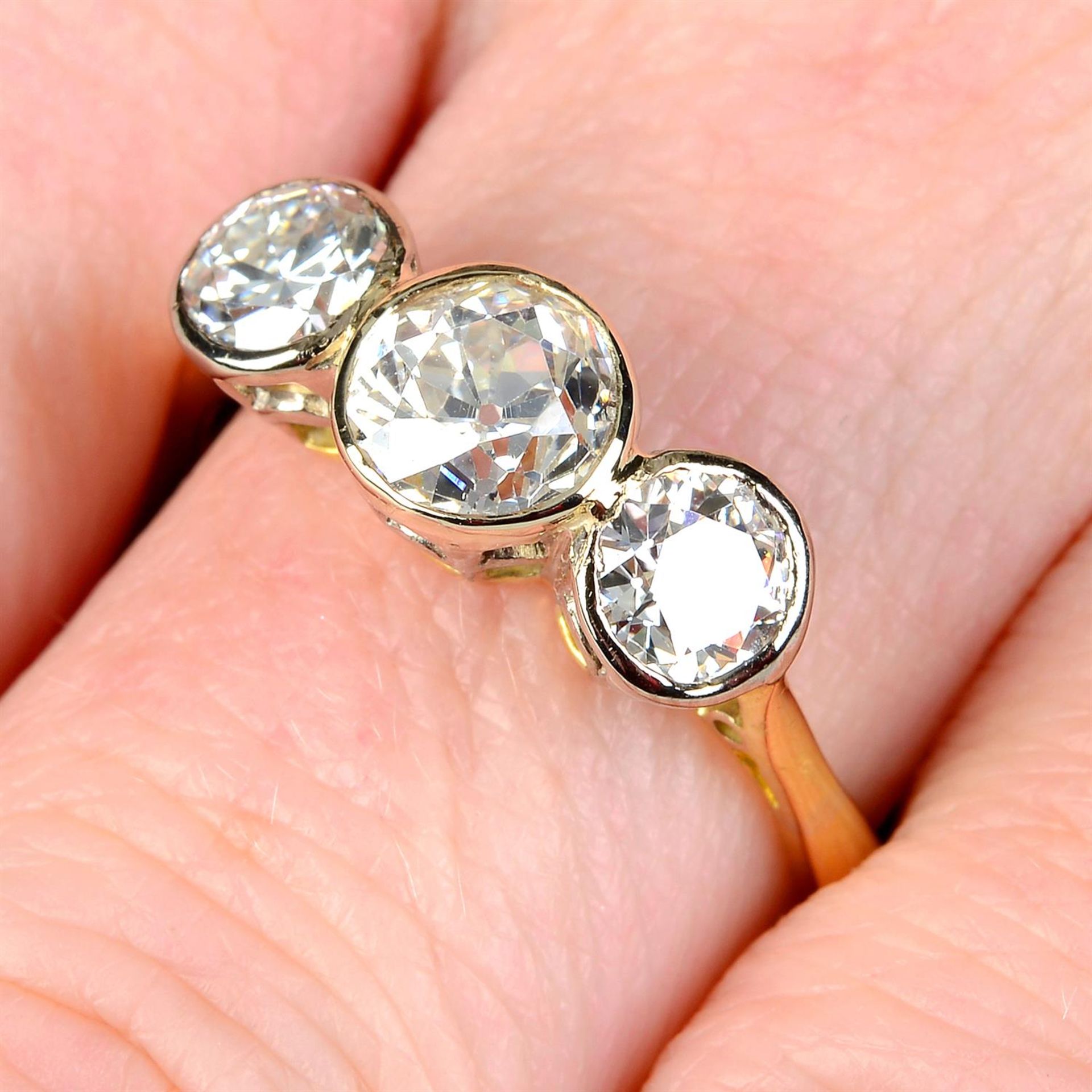 An 18ct gold graduated old-cut diamond three-stone ring.