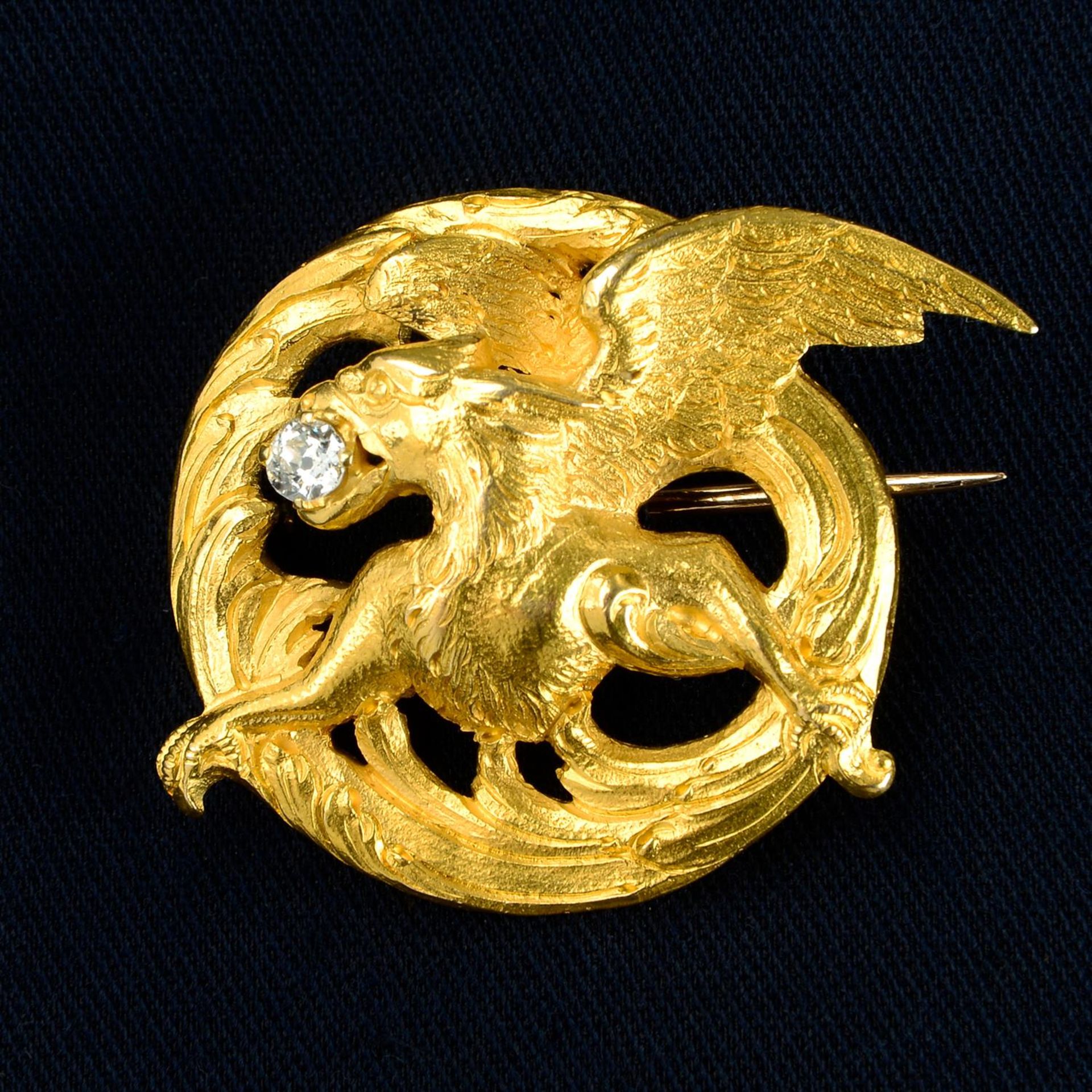 A late Victorian Art Nouveau 18ct gold griffin brooch, with old-cut diamond highlight.