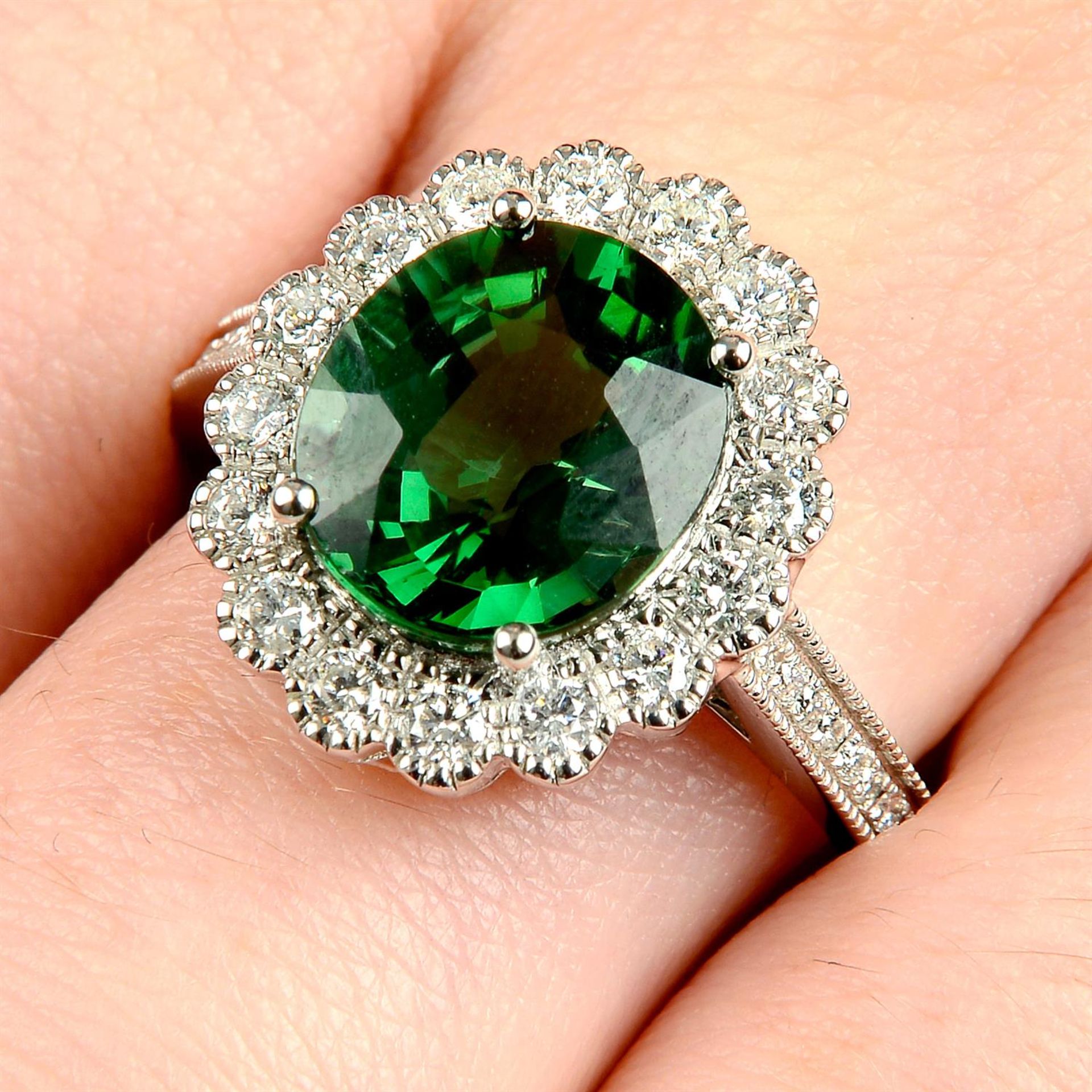 An 18ct gold green tourmaline and diamond cluster ring.